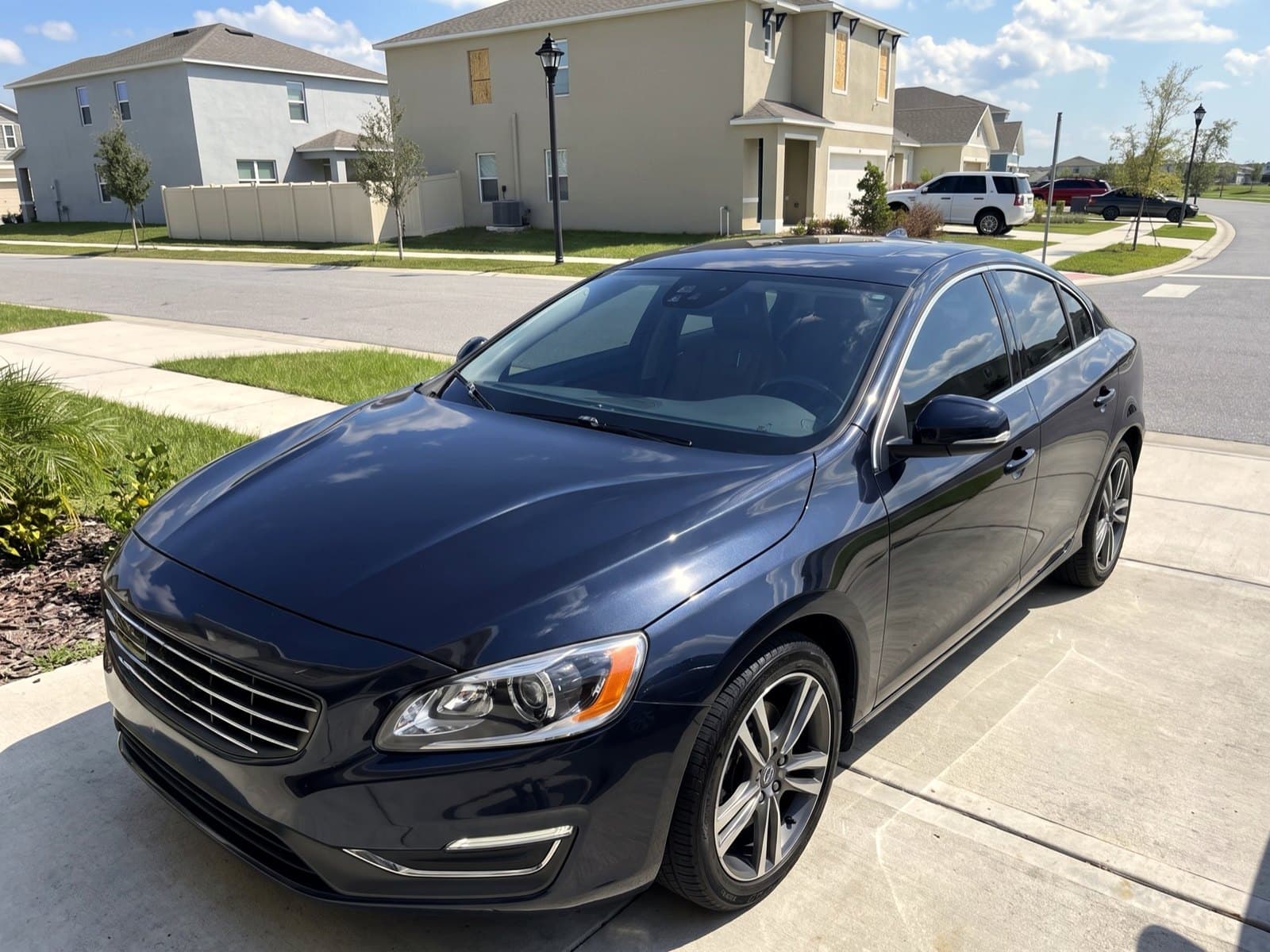 A dark blue sedan on a residential street in Auburndale, FL, after a Bang AutoGlass mobile glass job