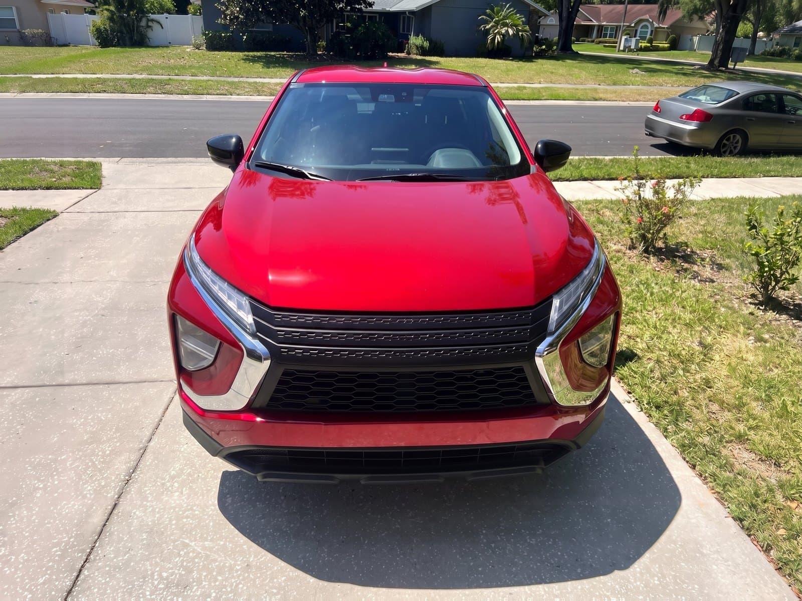 A red compact SUV in a driveway in Lake Mary, FL, after a Bang AutoGlass mobile glass job