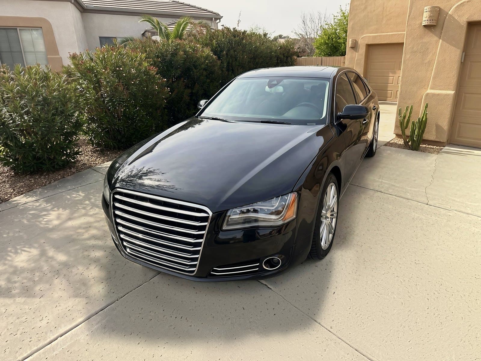 A black sedan in a driveway in Litchfield Park, AZ, after a Bang AutoGlass mobile glass job
