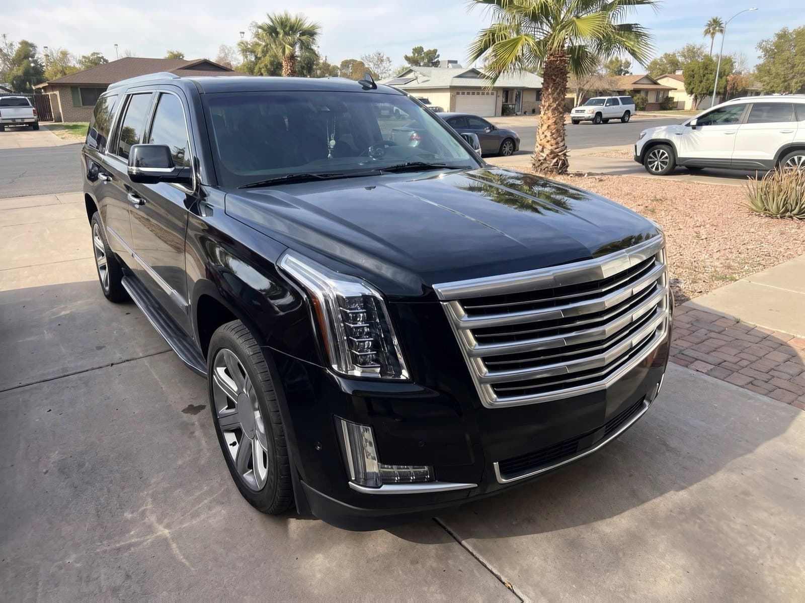 A black SUV in a driveway in Tempe, AZ, after a Bang AutoGlass mobile glass job