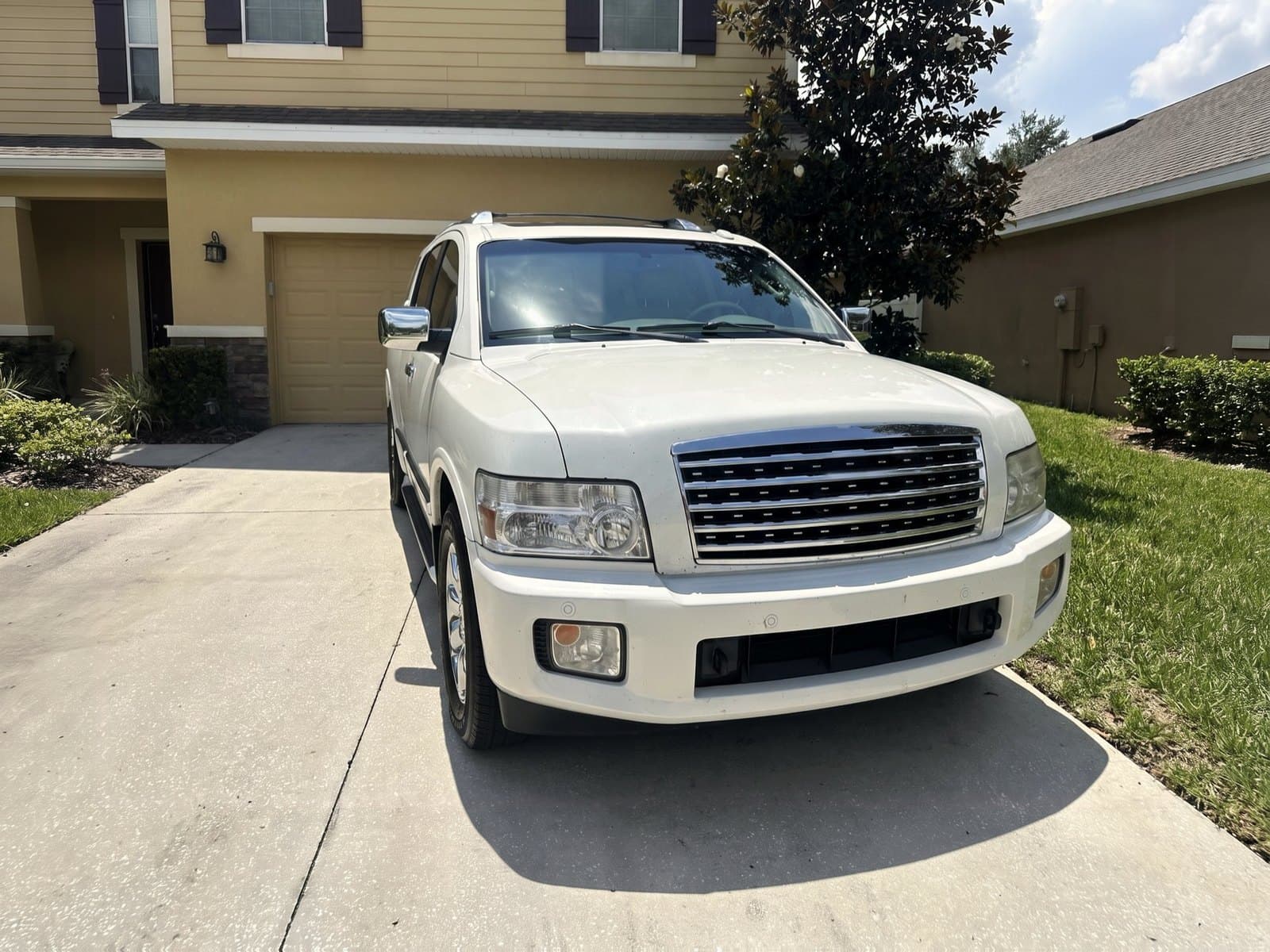 A white SUV in front of a garage in West Melbourne, FL, after a Bang AutoGlass mobile glass job