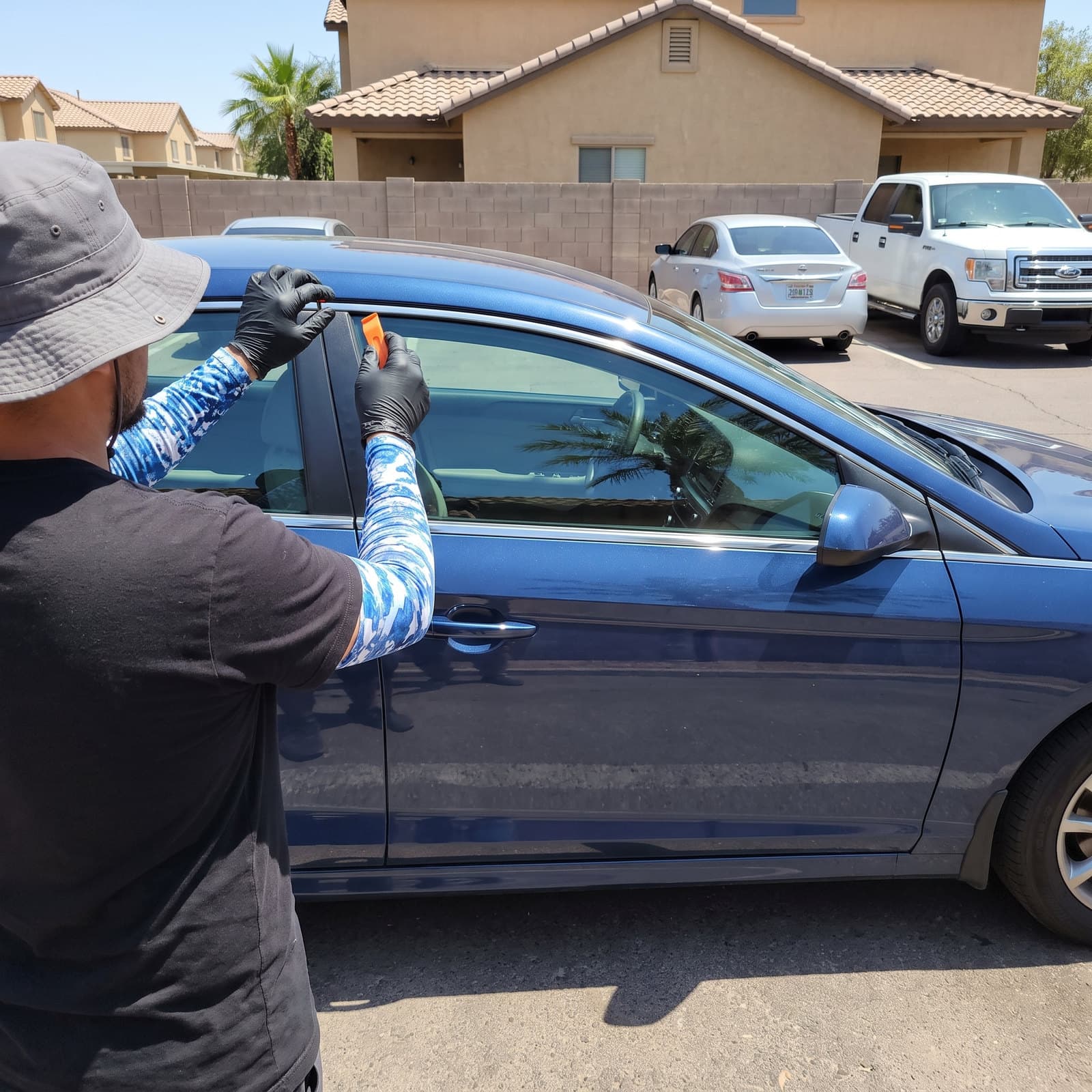 Bang AutoGlass technician fitting new door glass at the roadside