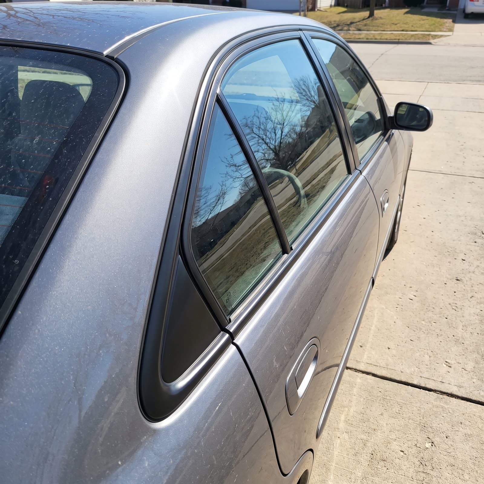 Replacement quarter glass fitted to a sedan