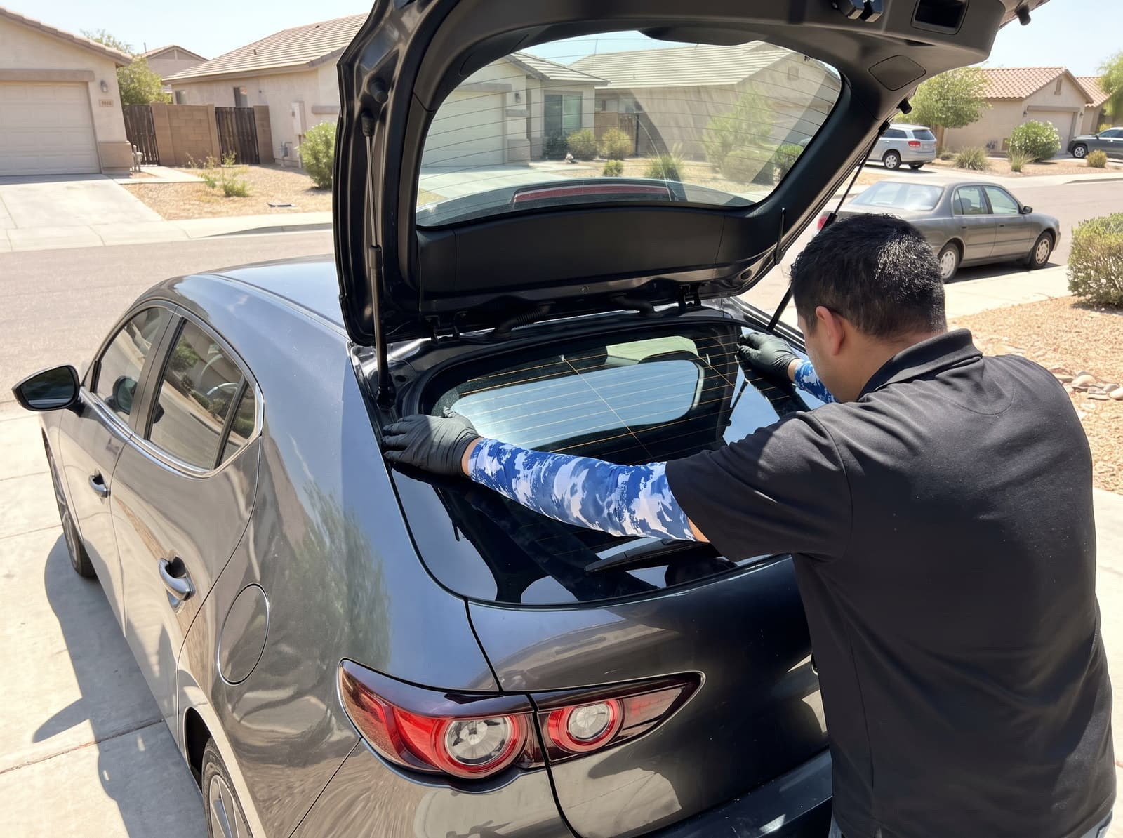 Tailgate raised with the new back glass set and its ceramic frit band in place