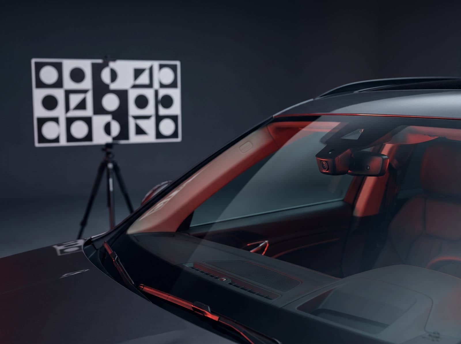 Windshield-mounted ADAS camera and calibration target — recalibration Bang AutoGlass performs in-house after windshield replacement